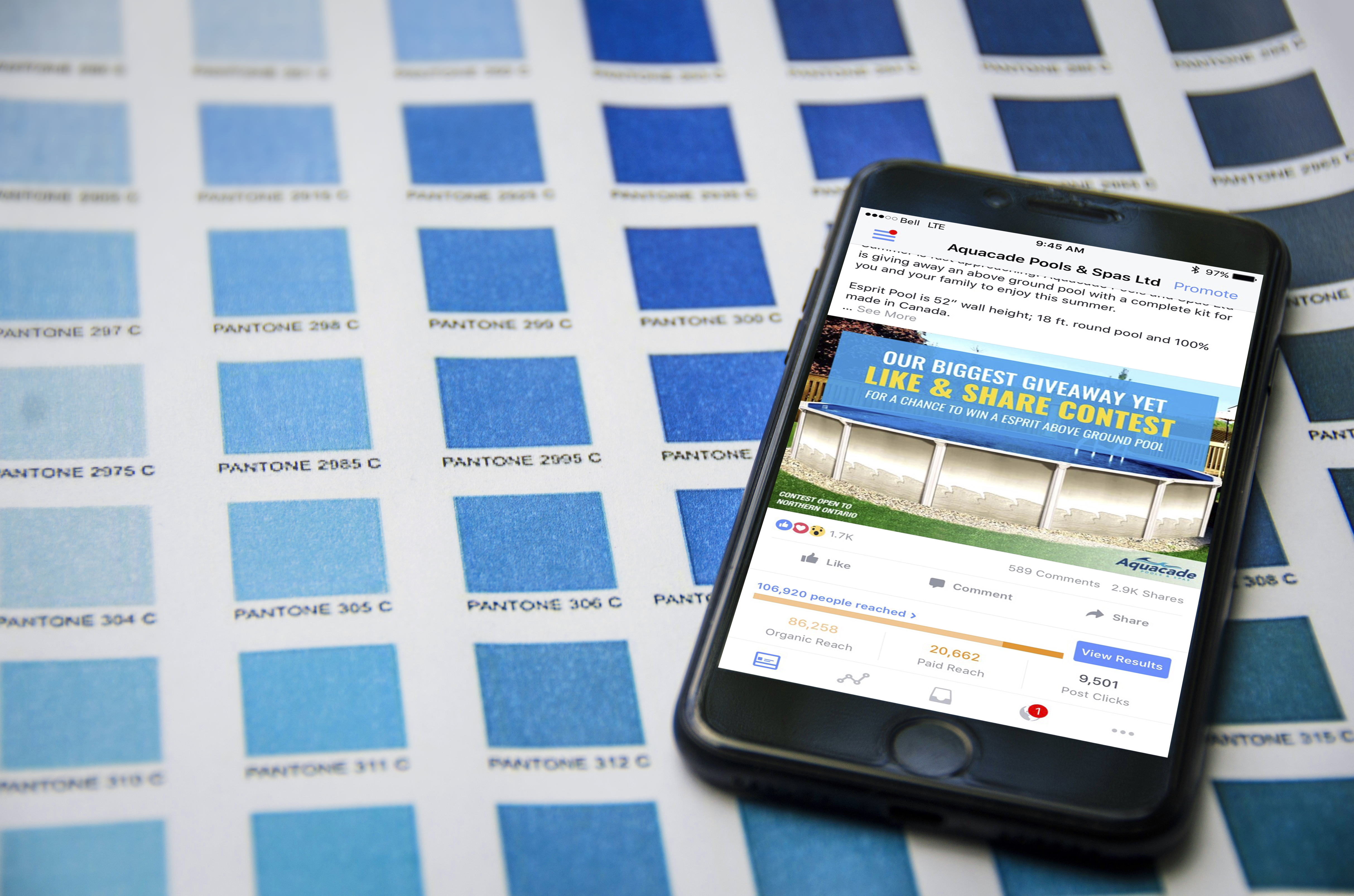 Cellphone with Statistics for a Facebook Contest on top of blue colour swatches