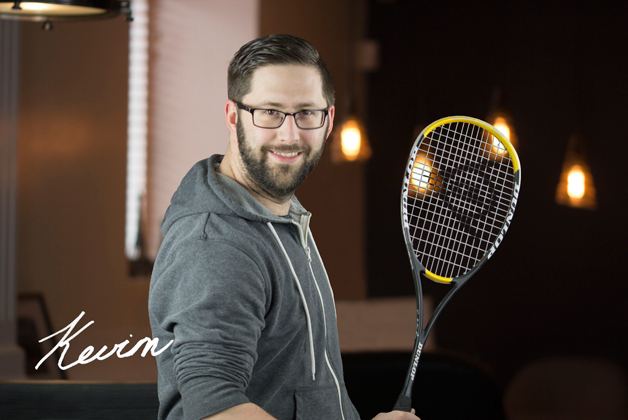 Headshot of Kevin Suchy holding tennis racket with his signature