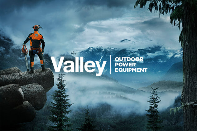 Valley Outdoor Power Equipment branding designed above man standing cliffside holding a chainsaw